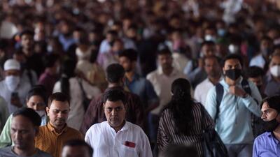 Mumbai, India - April 01, 2022: With the State government lifting all Covid-19 restrictions, commuters seen without masks on a crowded railway bridge at Dadar staion, in Mumbai, India, on Friday, April 01, 2022. (Photo by Satish Bate/Hindustan Times) (Satish Bate/HT PHOTO)