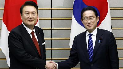 South Korean President Yoon Suk-yeol (left) and Japanese Prime Minister Fumio Kishida shake hands, ahead of their bilateral meeting at the Prime Minister's Office, in Tokyo, Japan, on Thursday. (AP) South Korean President Yoon Suk-yeol (left) and Japanese Prime Minister Fumio Kishida shake hands, ahead of their bilateral meeting at the Prime Minister's Office, in Tokyo, Japan, on Thursday. (AP)