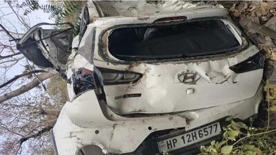 The car that skidded off the road and rolled down a hill near Kasauli in Solan district on Thursday morning. (HT Photo)