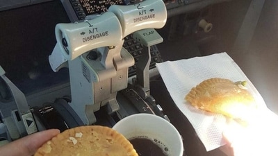 A viral picture of pilots having coffee and gujiyas inside cockpit. A viral picture of pilots having coffee and gujiyas inside cockpit.
