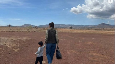Kareena holding little Jehangir's hand as they walk around the arid lands of Kenya. Kareena holding little Jehangir's hand as they walk around the arid lands of Kenya.