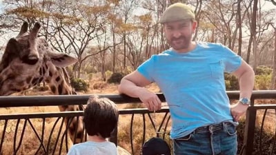 Saif Ali Khan poses for Kareena as Taimur and Jehangir stay busy looking at giraffes. Saif Ali Khan poses for Kareena as Taimur and Jehangir stay busy looking at giraffes. 