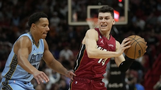 Miami Heat guard Tyler Herro (14) looks to pass under pressure from Memphis Grizzlies guard Desmond Bane (22). (AP)