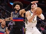  Andrew Nembhard #2 of the Indiana Pacers tries to drive around Isaiah Livers #12 of the Detroit Pistons during the first half at Little Caesars Arena on March 13, 2023 in Detroit, Michigan. 
