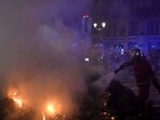 France Protests: A French firefighter puts out a fire lit by protesters during a demonstration after the French government pushed a pensions reform through parliament without a vote. France Protests: A French firefighter puts out a fire lit by protesters during a demonstration after the French government pushed a pensions reform through parliament without a vote.