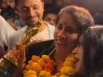 Guneet Monga was welcomed back to India with garlands and hugs. Guneet Monga was welcomed back to India with garlands and hugs.