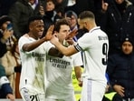Real Madrid's Vinicius Junior celebrates scoring their third goal with Karim Benzema and a teammate