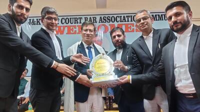 Chief Justice of J&K and Ladakh High Court Justice N Kotiswar Singh being felicitated by Jammu and Kashmir High Court Bar Association president advocate Vikram Sharma and others in Jammu on Friday. (HT Photo)