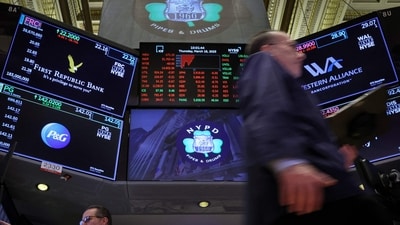 Traders work at the post where First Republic Bank stock is traded on the floor of the New York Stock Exchange (NYSE) in New York City. (REUTERS)