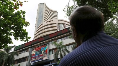 A man looks at a screen across a road displaying the Sensex on the facade of the Bombay Stock Exchange (BSE) building in Mumbai, India. (File image) (REUTERS)