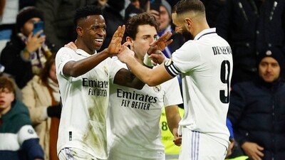 Real Madrid's Vinicius Junior celebrates scoring their third goal with Karim Benzema and a teammate (REUTERS)