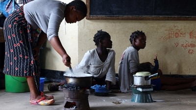 Cyclone Freddy in Malawi: Displaced flood victims from Chiradzulu district cook at Montfort Primary School which is used for temporary shelter, after their homes were damaged by mudslides and rockfalls in the aftermath of Cyclone Freddy. (Reuters)