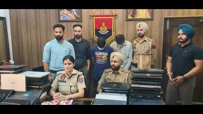 The accused and the recovered laptops in the custody of Mohali police. (HT Photo) The accused and the recovered laptops in the custody of Mohali police. (HT Photo)