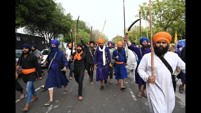 Armed protesters taking out a march in support of Amritpal Singh in Mohali on Saturday. (Ravi Kumar/HT)