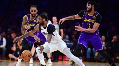 Dallas Mavericks guard Kyrie Irving (2) moves the ball against Los Angeles Lakers guard D'Angelo Russell (1) and forward Anthony Davis (3) during the second half at Crypto.com Arena. (USA TODAY Sports)