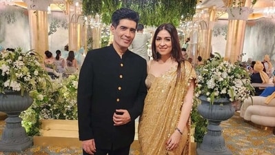 Bhavana Panday, who wore a golden saree for the wedding, posed with designer Manish Malhotra in a photo. Bhavana Panday, who wore a golden saree for the wedding, posed with designer Manish Malhotra in a photo.