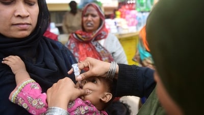 Polio Case In Pakistan: A health worker administers polio vaccine drops to a child at a railway station during a vaccination campaign in Karachi. (AFP) Polio Case In Pakistan: A health worker administers polio vaccine drops to a child at a railway station during a vaccination campaign in Karachi. (AFP)