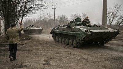 A local resident waves at a Ukrainian infantry fighting vehicle BMP-1 on their way to the frontline, near Bakhmut, eastern Ukraine, on March 17. (AFP) A local resident waves at a Ukrainian infantry fighting vehicle BMP-1 on their way to the frontline, near Bakhmut, eastern Ukraine, on March 17. (AFP)