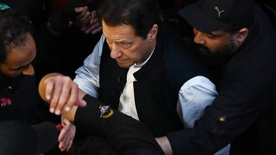 Imran Khan: Security personnel escort former Pakistan's Prime Minister Imran Khan as he arrives to appear at the high court in Lahore. (AFP) Imran Khan: Security personnel escort former Pakistan's Prime Minister Imran Khan as he arrives to appear at the high court in Lahore. (AFP)