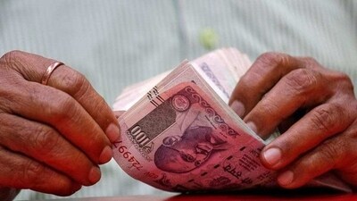 A man counts Indian currency notes inside a shop in Mumbai. The Indian rupee on Thursday had closed at 71.03 against the US dollar. (REUTERS) A man counts Indian currency notes inside a shop in Mumbai. The Indian rupee on Thursday had closed at 71.03 against the US dollar. (REUTERS)