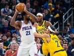  Philadelphia 76ers center Joel Embiid (21) looks to pass the ball while  Indiana Pacers guard Andrew Nembhard (2) defends in the first quarter at Gainbridge Fieldhouse. 