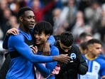Brighton's English striker Danny Welbeck (L) celebrates with Brighton's Japanese midfielder Kaoru Mitoma