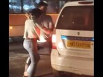 Screengrab of viral video showing a woman being shoved into a cab by a man, identified as her 'friend' by the police.