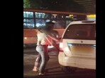 Screengrab from the viral video where a man was seen pushing a woman forcibly inside a cab. Screengrab from the viral video where a man was seen pushing a woman forcibly inside a cab.