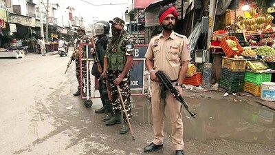Paramilitary personnel stand guard at Mehatpur village after the arrest of associates of Waris Punjab De chief Amritpal Singh in Jalandhar on Saturday. (ANI)