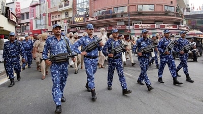 Police and Rapid Action Force (RAF) personnel conduct a flag march to instil a sense of security among the residents amid a search operation to nab Waris Punjab De chief Amritpal Singh, who is currently on the run, in Amritsar. (Raminder Pal Singh) Police and Rapid Action Force (RAF) personnel conduct a flag march to instil a sense of security among the residents amid a search operation to nab Waris Punjab De chief Amritpal Singh, who is currently on the run, in Amritsar. (Raminder Pal Singh)