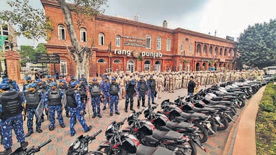 Amritsar police hold a flag march, amid a crackdown against Waris Punjab De chief Amritpal Singh and his aides, at Heritage street near Golden Temple on Sunday. (PTI) Amritsar police hold a flag march, amid a crackdown against Waris Punjab De chief Amritpal Singh and his aides, at Heritage street near Golden Temple on Sunday. (PTI)