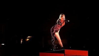 Taylor Swift&nbsp;in an asymmetrical red and black bodysuit. 