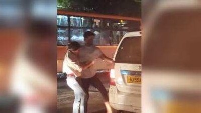 A screenshot of the video in which a man can be seen beating a woman and forcing her to get inside a cab.. A screenshot of the video in which a man can be seen beating a woman and forcing her to get inside a cab..