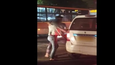 Screengrab from the viral video where a man was seen pushing a woman forcibly inside a cab. (ANI)