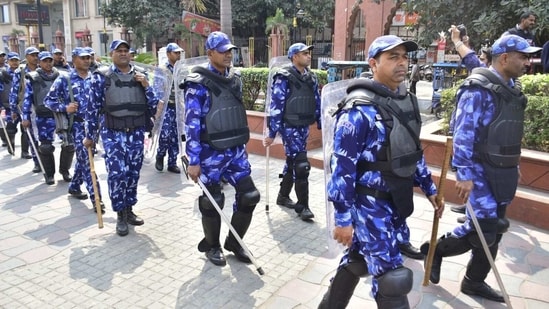 Rapid Action Force (RAF) and Punjab police personnel carry out a flag march in Amritsar amid bid to nab fugitive Amritpal Singh on Sunday.