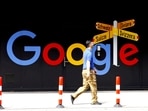 Google layoffs: A man walks past a logo of Alphabet Inc's Google in front of an office building in Zurich, Switzerland.