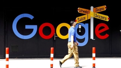 Google layoffs: A man walks past a logo of Alphabet Inc's Google in front of an office building in Zurich, Switzerland. (REUTERS)