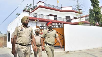 Punjab police personnel walk in front of house of Waris Punjab De Chief Amritpal Singh at village Jallupur Khera, Amritsar , India, on Sunday. (Sameer Sehgal /Hindustan Times) Punjab police personnel walk in front of house of Waris Punjab De Chief Amritpal Singh at village Jallupur Khera, Amritsar , India, on Sunday. (Sameer Sehgal /Hindustan Times)