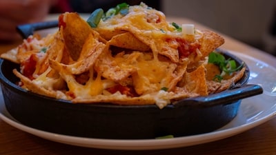 Nachos: Nothing beats a big plate of cheesy nachos on a rainy day. Whether you like them loaded with beans, guacamole, and sour cream or simply topped with melted cheese and jalapenos, nachos are the ultimate comfort food. (Unsplash)