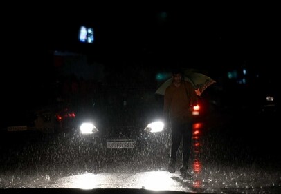 Commuters out in the rain on the Sector 12 road, in Noida, Up, on Monday. (Sunil Ghosh / Hindustan Times)