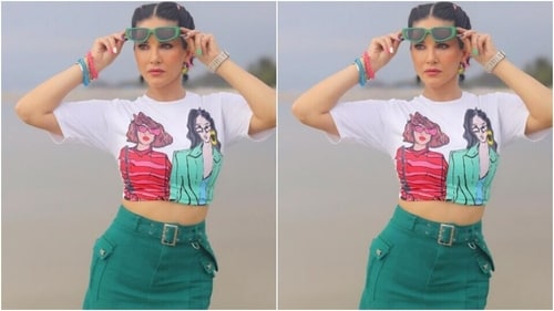 Sunny looked ravishing as ever in a white cropped top printed in quirky colours and graphic prints. She teamed it with a green short skirt with a silver belt. (Instagram/@sunnyleone) Sunny looked ravishing as ever in a white cropped top printed in quirky colours and graphic prints. She teamed it with a green short skirt with a silver belt. (Instagram/@sunnyleone)