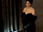 Deepika Padukone introduces the song Naatu Naatu from RRR at the Oscars on Sunday. For the event, Deepika wore a black dress and a silver-yellow neckpiece. (AP) Deepika Padukone introduces the song Naatu Naatu from RRR at the Oscars on Sunday. For the event, Deepika wore a black dress and a silver-yellow neckpiece. (AP)