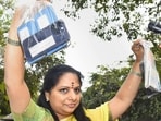 BRS MLC K Kavitha shows mobile phones as she leaves from the residence of her father, Telangana CM K Chandrashekar Rao, for the ED office in New Delhi on Tuesday.