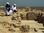 Journalists film uncovered ruins on Siniyah Island in Umm al-Quwain, United Arab Emirates, Monday, March 20, 2023. Archaeologists said Monday they have found the oldest pearling town in the Persian Gulf on an island off one of the northern sheikhdoms of the United Arab Emirates. 