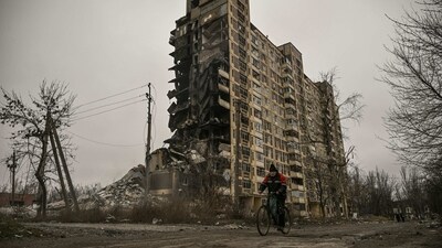 A man seen riding his bicycle in front of a destroyed apartment building after a Russian strike in Avdiivka, Donetsk Oblast, on March 18. For months, authorities have been urging civilians in areas near the fighting to evacuate to safer parts of the country. But while many have heeded the call, others — including families with children — have steadfastly refused. (Aris Messinis / AFP) A man seen riding his bicycle in front of a destroyed apartment building after a Russian strike in Avdiivka, Donetsk Oblast, on March 18. For months, authorities have been urging civilians in areas near the fighting to evacuate to safer parts of the country. But while many have heeded the call, others — including families with children — have steadfastly refused. (Aris Messinis / AFP)
