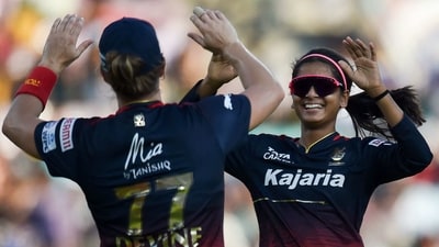 Royal Challengers Bangalore's Shreyanka Patil celebrates with a teammate after the dismissal of Mumbai Indians' Yastika Bhatia (AFP)