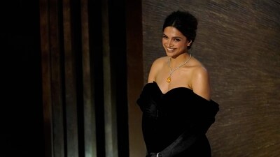 Deepika Padukone introduces the song Naatu Naatu from RRR at the Oscars on Sunday. For the event, Deepika wore a black dress and a silver-yellow neckpiece. (AP)