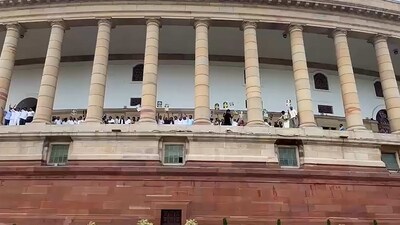 Opposition MPs protest on the first floor of the Parliament demanding a joint parliamentary committee (JPC) probe into the Adani Group issue during the Budget Session, in New Delhi, Tuesday, March 21, 2023. (PTI Photo) Opposition MPs protest on the first floor of the Parliament demanding a joint parliamentary committee (JPC) probe into the Adani Group issue during the Budget Session, in New Delhi, Tuesday, March 21, 2023. (PTI Photo)