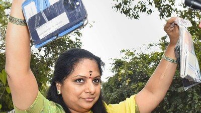 BRS MLC K Kavitha shows mobile phones as she leaves from the residence of her father, Telangana CM K Chandrashekar Rao, for the ED office in New Delhi on Tuesday. (PTI) BRS MLC K Kavitha shows mobile phones as she leaves from the residence of her father, Telangana CM K Chandrashekar Rao, for the ED office in New Delhi on Tuesday. (PTI)