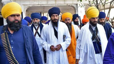 Sikh radical leader and Waris Punjab De chief Amritpal Singh (centre) has been absconding since Saturday. The stringent NSA Act has been invoked against him and his role is being probed in five criminal cases. (Reuters file photo)